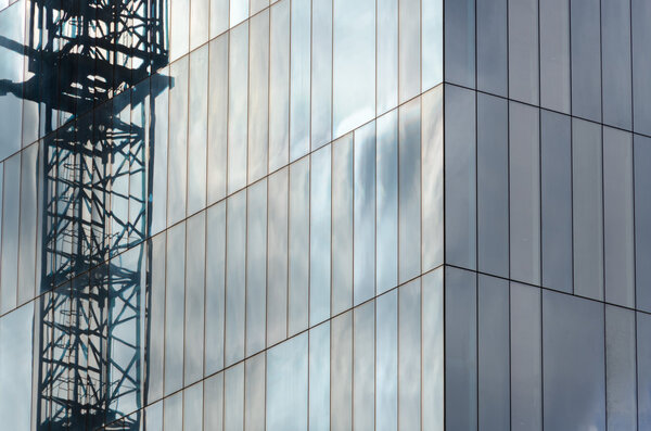 Reflection of a crane in a skyscraper in mirrors
