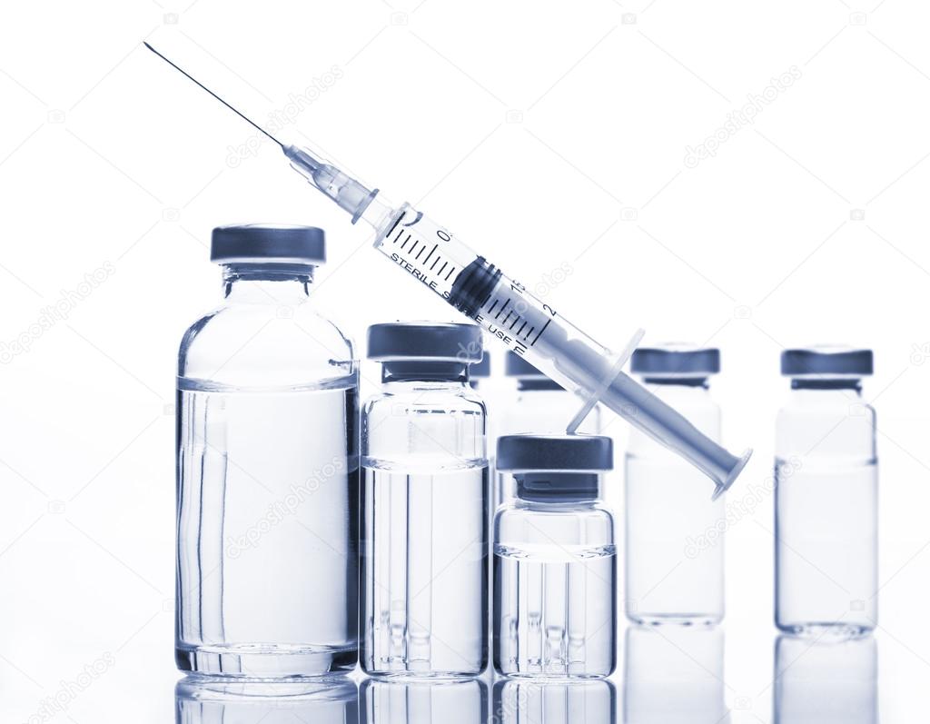 Glass Medicine Vials and Syringe on white background