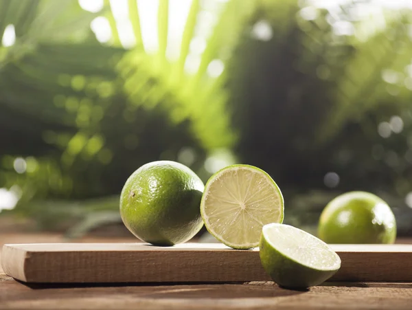 Fresh limes on wooden background — Stock Photo, Image