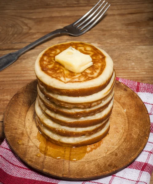 Pancakes with honey and butter on wooden background — Stock Photo, Image