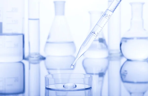 Test-tubes on a white and blue background. — Stock Photo, Image