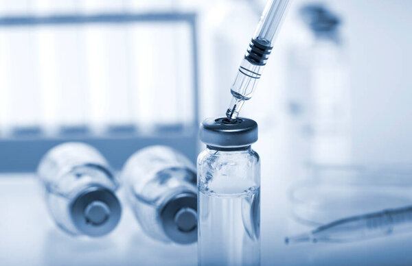 Test-tubes with on a white and blue background. Laboratory glassware.