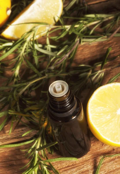 Lemon essential oil and rosemary — Stock Photo, Image