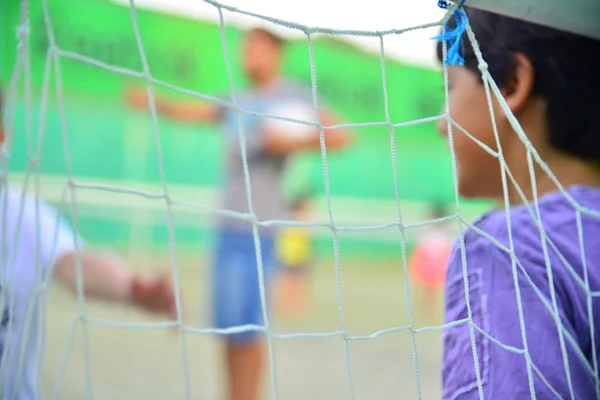 Boys playing friendly football soccer game outdoors Stock Image