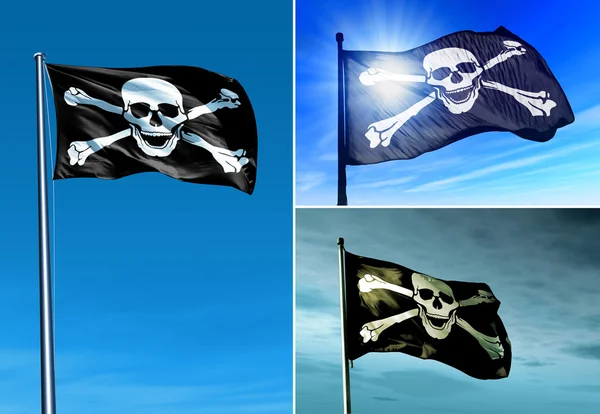 Bandera pirata de cráneo y huesos cruzados ondeando en el viento —  Fotos de Stock