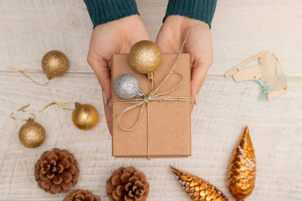 Vlakke Lay Van Een Kerstcadeau Handen Van Vrouw Decoratie Ballen — Stockfoto