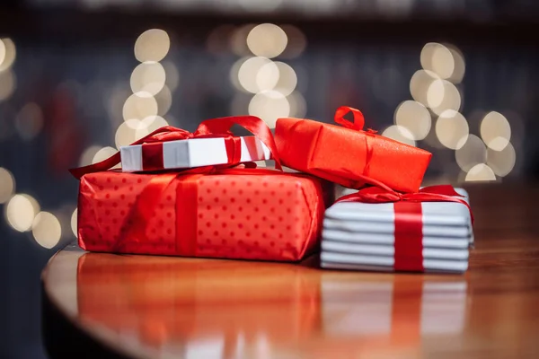 Valentine\'s Day, Christmas and New Year presents concept. A pile of gift boxes on the table at a cafe. A stack of presents on a wooden surface at a restaurant. New normal and winter holidays