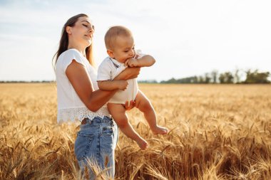 Bir anne oğlunu altın buğday tarlasında elinde tutar. Çocuğuyla birlikte dışarı çıkıp eğlenen ve iyi günlerin tadını çıkaran bir kadın. Aile değerleri ve eğlence kavramı