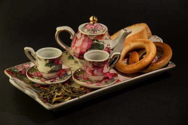 Porcelian mini tea set with bagels — Stock Photo, Image