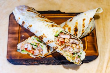 Yumuşak ızgara tavuk, taze sebzeler ve ahşap bir tahtada lezzetli tatlar, hızlı bir yemek için mükemmel..