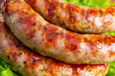 Sosisler ızgarada pişirilir ve yaz boyunca arka bahçede marulların üzerinde servis edilir..