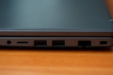 Bir dizüstü bilgisayarın yakın görüntüsü USB, HDMI ve kart okuyucu da dahil olmak üzere çeşitli portları gösterir. Bu ayar farklı aygıtları bağlamak için yararlıdır.