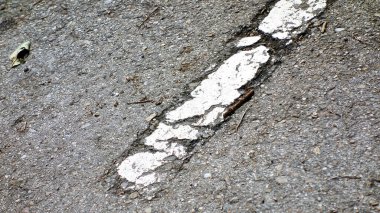 Painted white line of a road eroded by the passage of time