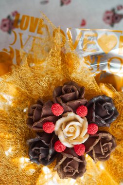 valentines day concept, chocolate bouquet of roses in gold packaging, copy space