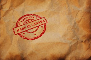 CANADA damgası buruşuk kağıt parçalarına basılmış. Kanada ürünü, paket, paket, üretim lojistik konsepti. Tasarım için telif alanı olan arkaplan