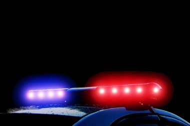 Police car with red and blue flashing lights on street at night time, crime scene. Emergency vehicle lights flashing clipart