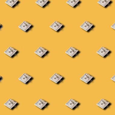 Yaratıcı model sarı arka planda 100 dolarlık banknotlar yapmış. Asgari mali iş kavramı