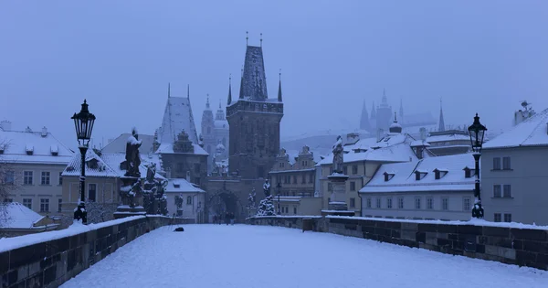 Ранним утром романтический снежный Прага Малый город с готическим замком, мост башня и собор Святого Николая от Карлова моста с его барочных статуй, Чешская республика — стоковое фото
