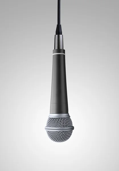 Vzhůru nohama mikrofon na šedém pozadí — Stock fotografie