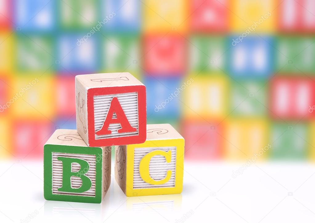 ABC blocks on a colorful blurred background