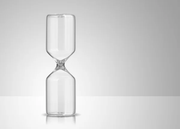 Empty hourglass on gray background — Stock Photo, Image