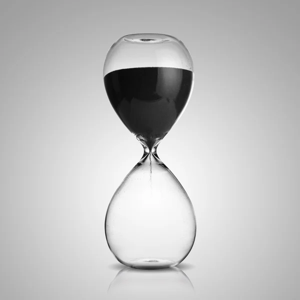 Hourglass on gray background — Stock Photo, Image
