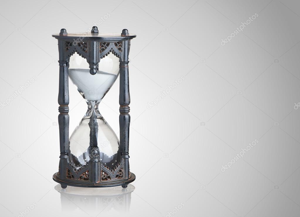 Vintage hourglass on gray background
