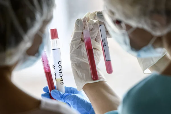 People Protective Suits Face Masks Look Test Tubes Samples Vaccine — Stock Photo, Image