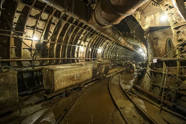 Trolleys stand in the deep underground metro tunnel. Construction of a subway line in the Dnipro city, Ukraine.