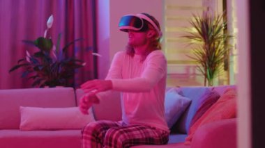 Korkak, maceracı, uzun saçlı, online dalış simülatöründe oynayan, su altında yüzen, karantinada eğlenen bir adam. Neon ışıkları. Etkinlikler.