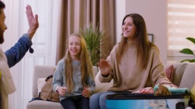 Genç bir aile seyahat çantasına giysilerini koyar. Evde kedilerle oynarlar. Gülümseyerek mutlu ol. Kızı ebeveynlerine yardım ediyor. Turizm çifti macera yaşam tarzı. Yavaş çekim