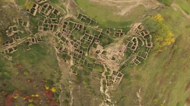 Abandonado en las montañas, el pueblo de Gamsutl. Fortaleza inexpugnable en la cima. Pueblo fantasma, ruinas de un antiguo asentamiento. 4k vista aérea de un antiguo pueblo abandonado en las montañas de Daguestán — Vídeo de stock