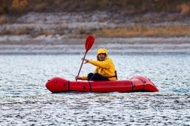 Paket, tek kişilik hafif sal. Sefer ya da macera olsun diye gölde yarışmak için kullanılıyor. Şişme tekne dağ gölünde gezintiye çıkıyor.