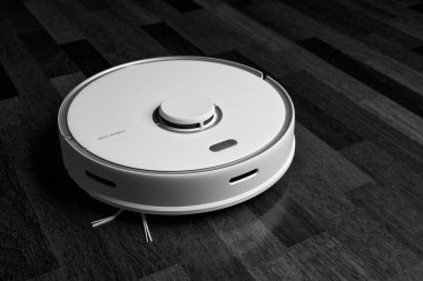 Smart Robot Vacuum Cleaner Xiaomi roborock s5 max on wood floor. Robot vacuum cleaner performs automatic cleaning of the apartment. 04.12.2020, Rostov region, Russia clipart