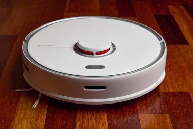 Smart Robot Vacuum Cleaner Xiaomi roborock s5 max on wood floor. Robot vacuum cleaner performs automatic cleaning of the apartment. 04.12.2020, Rostov region, Russia clipart