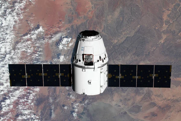 The SpaceX Dragon resupply ship is pictured approaching the International Space Station. Elements of this image furnished by NASA — Stock Photo, Image