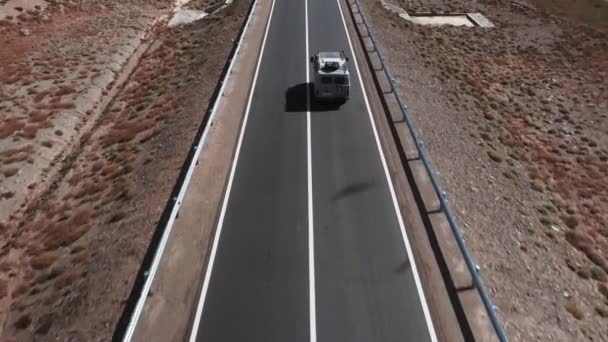 車は道路を進みます 山の中で美しい舗装道路 新しい高速道路だ 野生の山の風景です 砂漠を巡るロードトリップ — ストック動画