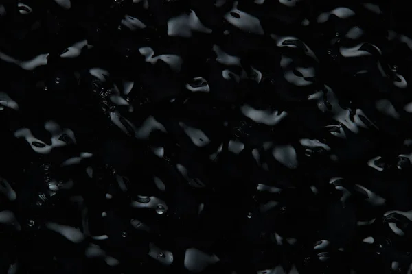 Vibration on the surface of the liquid. Abstract Black Background Liquid Texture