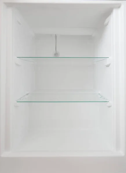 An empty refrigerator. Inside an empty, clean refrigerator, a refrigerator compartment after defrosting