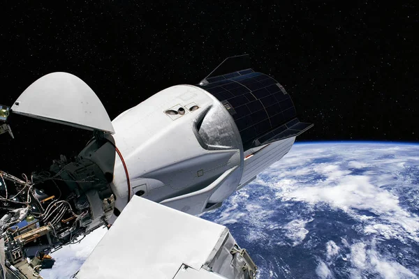 The SpaceX Crew Dragon spacecraft is docked to the International Space Station. Elements of this image furnished by NASA.