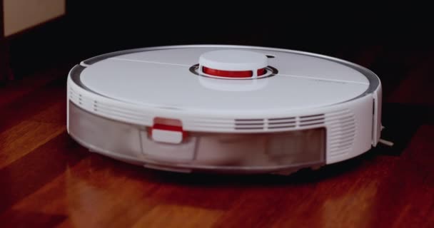 Smart Robot Vacuum Cleaner with lidar on wood floor. Robot vacuum cleaner performs automatic cleaning of the apartment. 4K slow motion 100 fps, ProRes 422, 10 bit — Stock Video