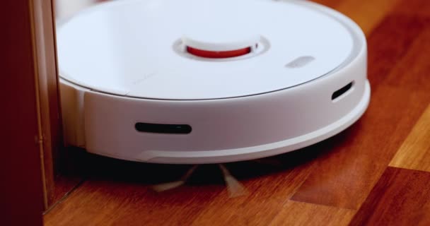 Smart Robot Vacuum Cleaner with lidar on wood floor. Robot vacuum cleaner performs automatic cleaning of the apartment. 4K slow motion 100 fps, ProRes 422, 10 bit — Stock Video