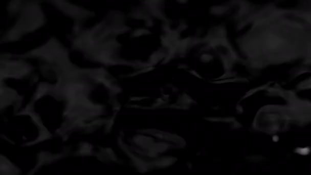 Splashes and drops on the surface of the liquid. Abstract Black Background Water vibration. 4K slow motion 100 fps, ProRes 422, 10 bit — Vídeo de Stock