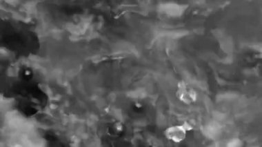 Splashes and drops on the surface of the liquid. Abstract Black Background Water vibration. 4K slow motion 100 fps, ProRes 422, 10 bit