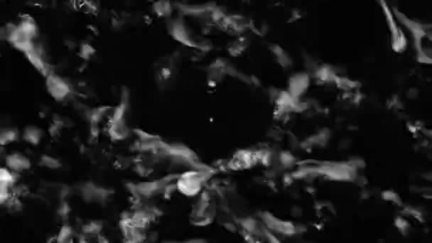 Splashes and drops on the surface of the liquid. Abstract Black Background Water vibration. 4K slow motion 100 fps, ProRes 422, 10 bit — Stock video