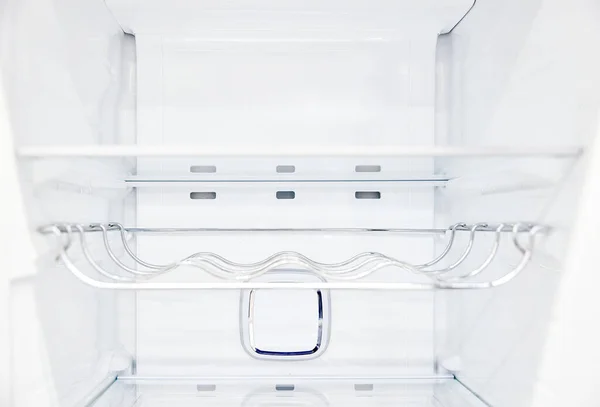 An empty refrigerator. Inside an empty, clean refrigerator, a refrigerator compartment after defrosting