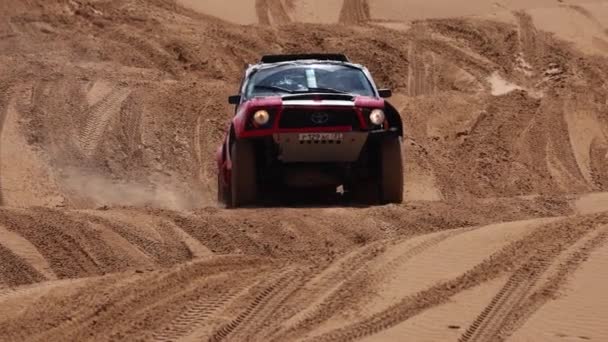 Sport car for Off Road Extreme Racing gets over the difficult part of the route during the Rally raid in sand. THE GOLD OF KAGAN-2021. slow motion 120 fps. 25.04.2021 Astrakhan, Russia — Stock Video