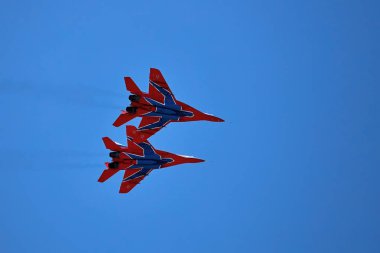 Airshow of the aerobatic team Strizhi (The Swifts). Aerobatic Team on fighters Mig-29, Russian Air Force, on at the International Aviation and Space salon MAKS 2019. ZHUKOVSKY, RUSSIA, 08,27,2019. clipart