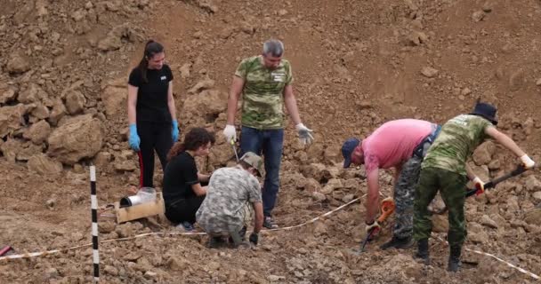Εργασίες της ομάδας έρευνας στο χώρο μαζικών πυροβολισμών ανθρώπων. Ανθρώπινα οστά σκελετού, κρανία στο έδαφος. Θύματα των Ναζί. 28.08.2021, περιφέρεια Rostov, Ρωσία — Αρχείο Βίντεο