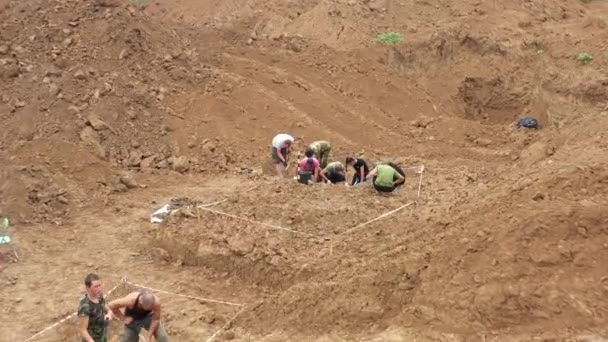 Excavations at the site of a war crime. Site of a mass shooting of people. Human remains bones of skeleton, skulls . Human remains of victims of the Nazis. 28.08.2021, Rostov region, Russia — Stock Video